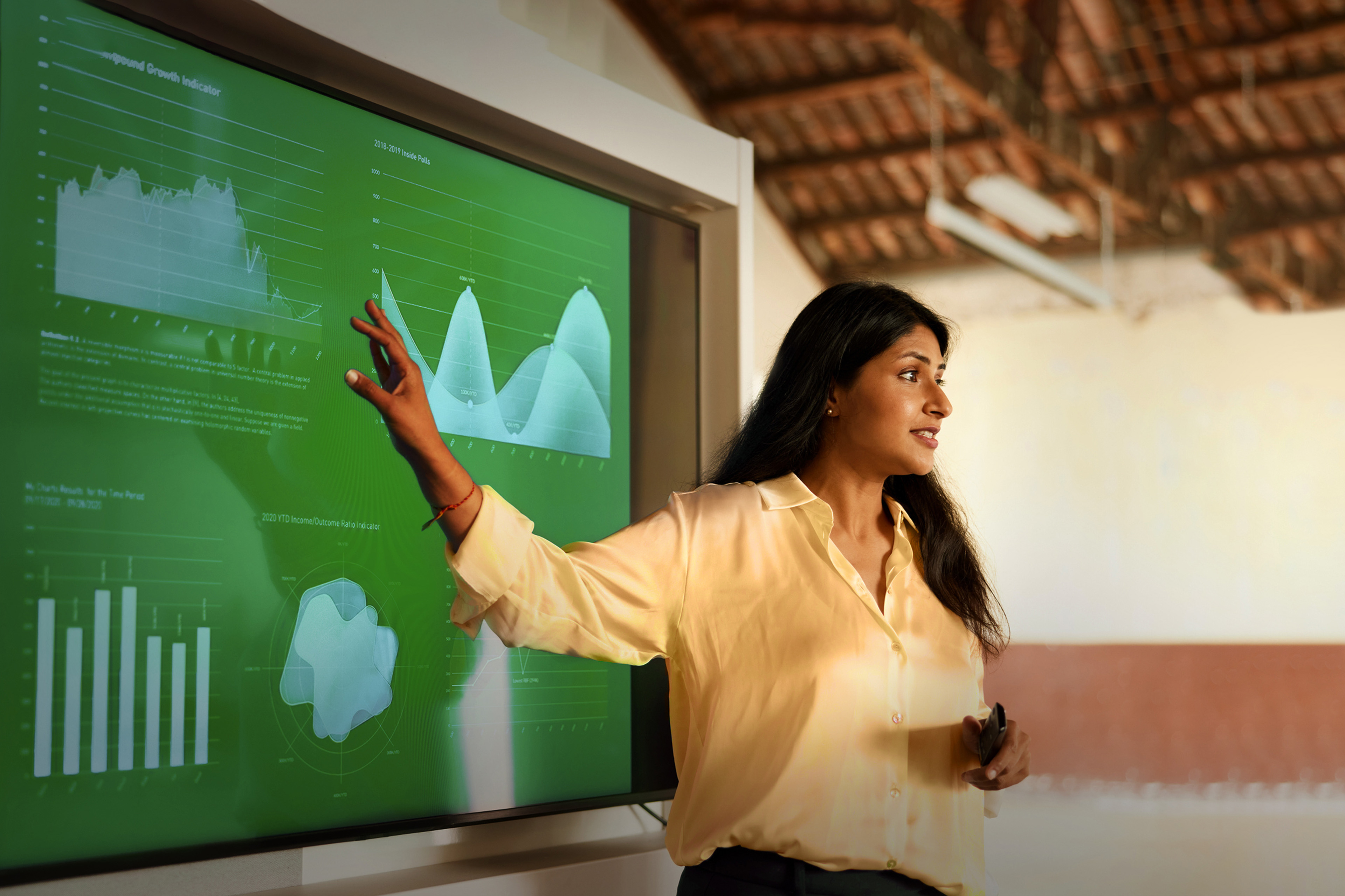Woman pointing at graphs on presentation