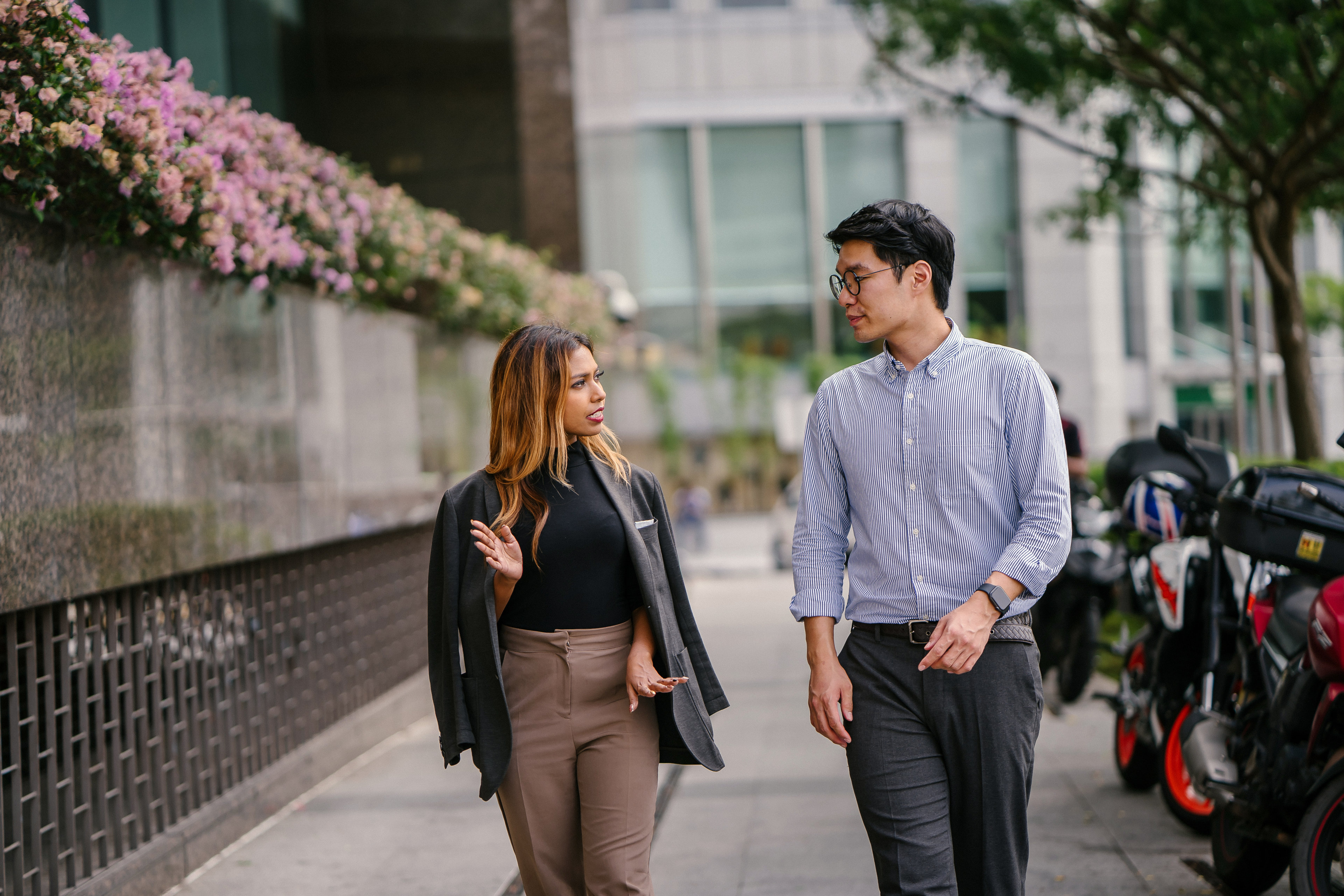 Two business professionals having conversation while walking