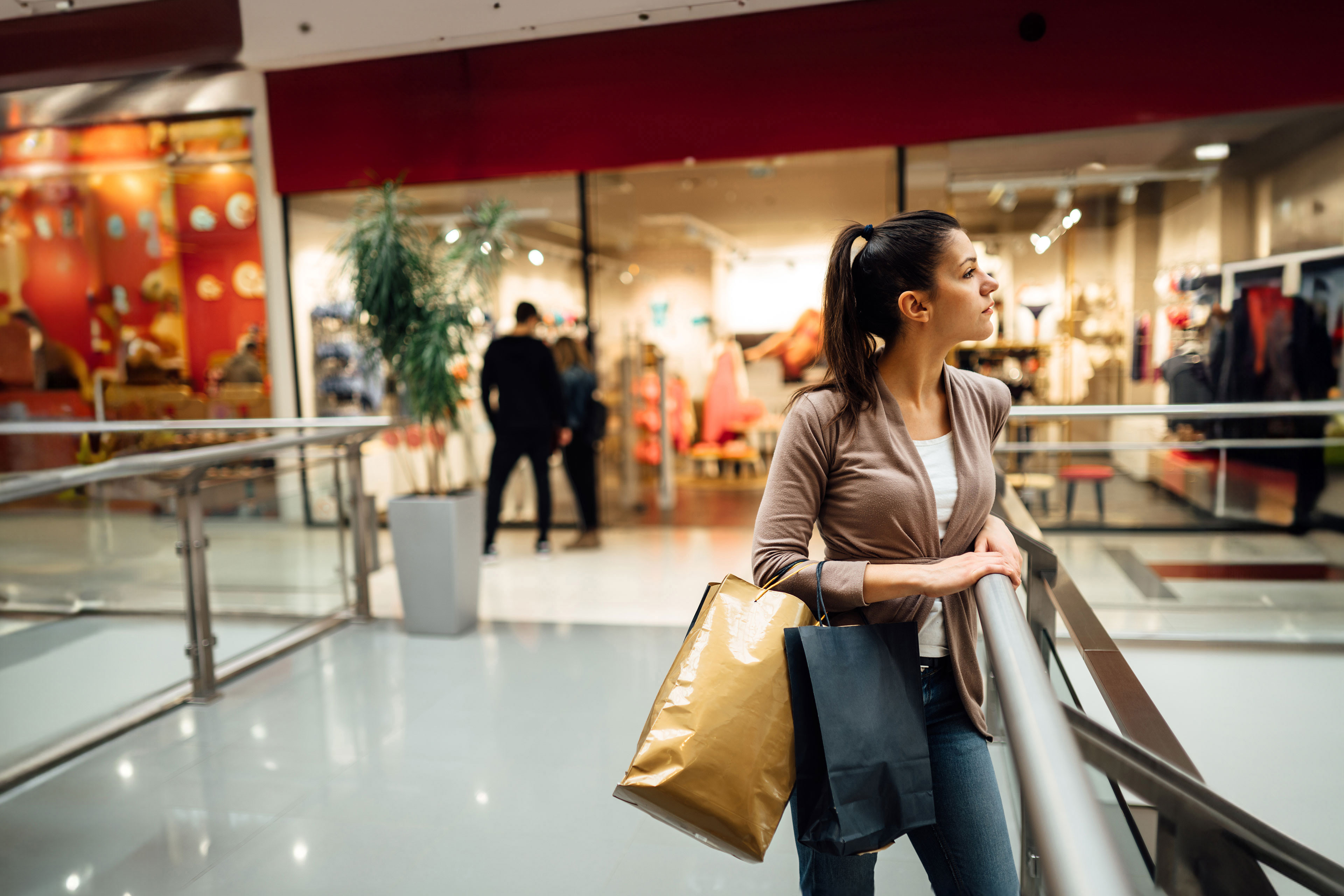 Woman standing inside shopping mall